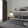 a bed with a picture on the wall and a large window