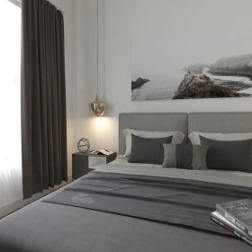 Beautiful bedrooms to fit every need a bed with a picture on the wall and a large window